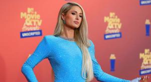 Paris Hilton poses in a blue dress at the at the MTV Movie and TV Awards in 2022