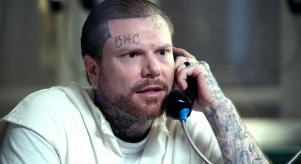 Adam Williams speaking on a prison phone during an interview