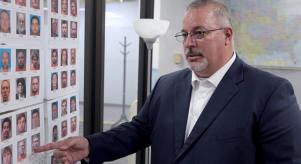 Detective Tony Godwin pointing at an evidence board