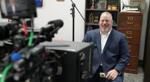 Tony Godwin smiles as he sits in front of a camera about to do an interview for Predator Hunters