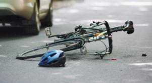 A bike and helmet lying on the road after being hit by a car