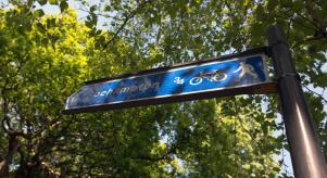A sign for Roehampton underneath some trees