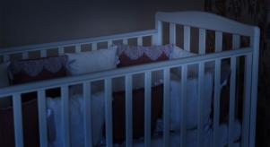 A baby's cot at nighttime