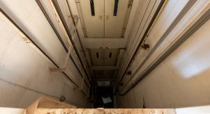 Looking down over an empty elevator shaft