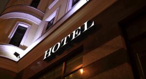 A sign outside a hotel at night