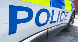 The word 'Police' written on the side of a police car