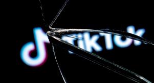 The TikTok logo in the reflection of a broken mirror