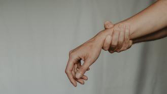 Someone grabbing the wrist of someone else