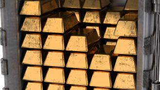 Gold bars stacked up in a safe