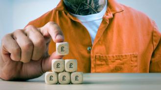 A graphic image of a prisoner building a pyramid out of dice