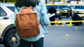 A stock image of a student looking at a crime scene