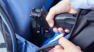 Taking a gun out of a child's backpack