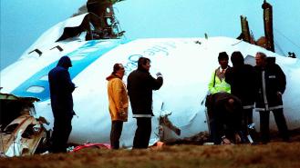 Crash investigators inspect the nose section of the crashed Pan Am Flight 103