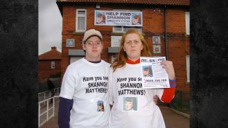 Karen Matthews with her partner Craig holding a poster appealing for her daughter