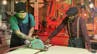 Taury Meade uses a buzz saw while his dad, Raphael, watches on