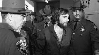 Ronald DeFeo Jr. is led away by police after a court hearing