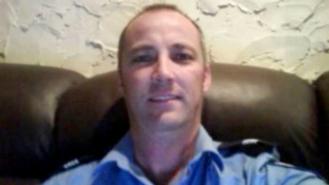 Adrian Trevor Moore takes a selfie while wearing his police uniform