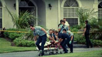 Paramedics wheel Marlene Warren to an ambulance after she was shot on her doorstep 