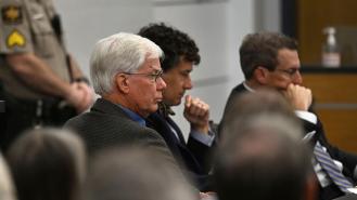 Thomas Martens sitting with his attorneys in court