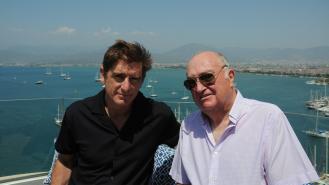 Marcel Theroux and Keith Cheeseman on a balcony overlooking the sea