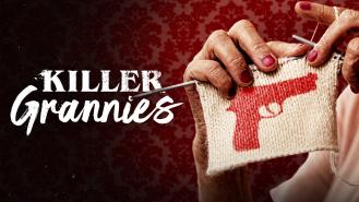 A granny knitting a red gun pattern on a white square