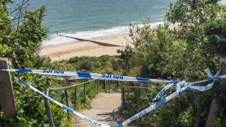 Police tape blocking off the steps down to Durley Chine Beach