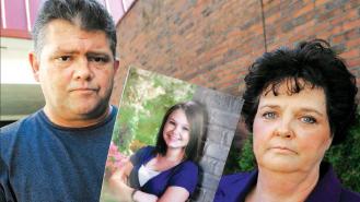 Dave and Mary Neese holding a photograph of their missing daughter, Skylar