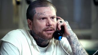 Adam Williams speaking on a prison phone during an interview
