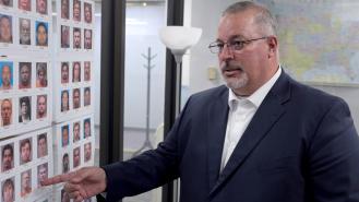 Detective Tony Godwin pointing at an evidence board
