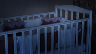 A baby's cot at nighttime