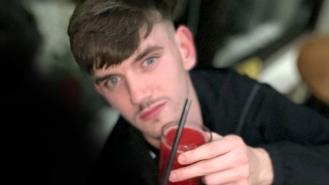 Tyler Kerry holding a red drink