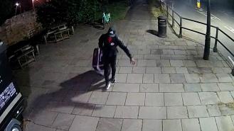 CCTV of Yostin Andres Mosquera wheeling a suitcase across the bridge