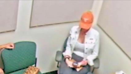 A photo of SanDee Jones being interrogated in a police station