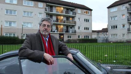 Douglas Skelton standing next to a black sports car