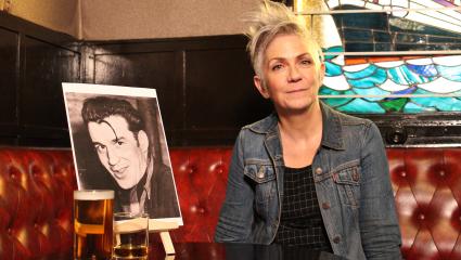 Denise Mina in a pub with a picture of Peter Manuel