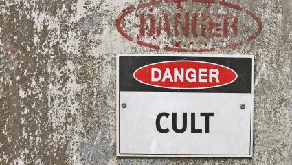 A sign on a wall warning 'Danger Cult'