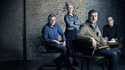 A photograph of the four authors from Once Upon A True Crime, sat around a table