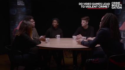 Students sitting around a table discussing if video games lead to violent crime