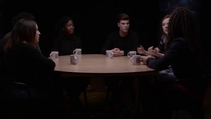 Group of students discussing a topic around a table