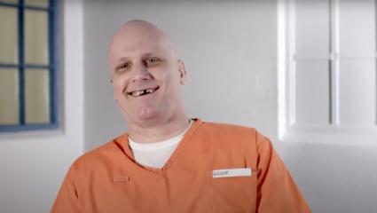 Prisoner James Robertson wearing an orange jumpsuit