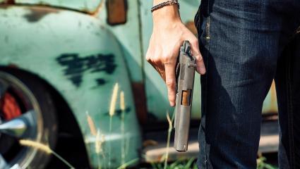 A man holds a handgun
