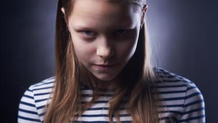 Portrait of a little girl with evil face