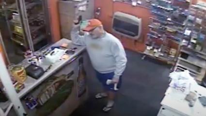 CCTV footage of a shopkeeper to holding a handgun