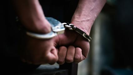 A stock photo of a man in handcuffs