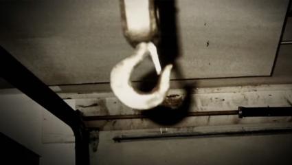 Police photo of a hook hanging from the ceiling in a dark room