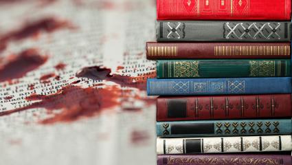 A stock image showing books and a blood stain on a book page