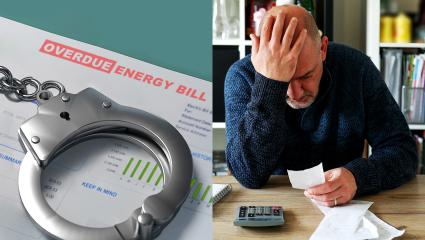 A man holds his head in anguish as he calculates his bills