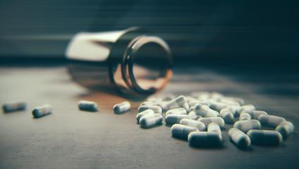 A stock image showing an open jar of pills