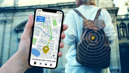 A stock image showing a mobile phone and a tracking device clipped onto a rucksack