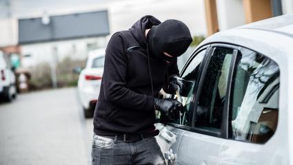 A man breaking into a car